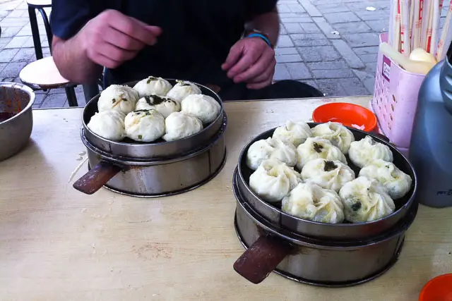 two steamers with dumplings on table Sampling some Chinese dumplings.