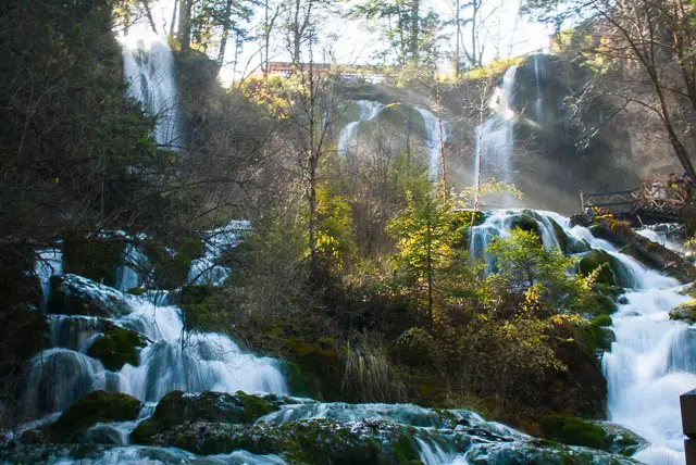 waterfall with sunbeams through trees at Jiuzhaigou in China